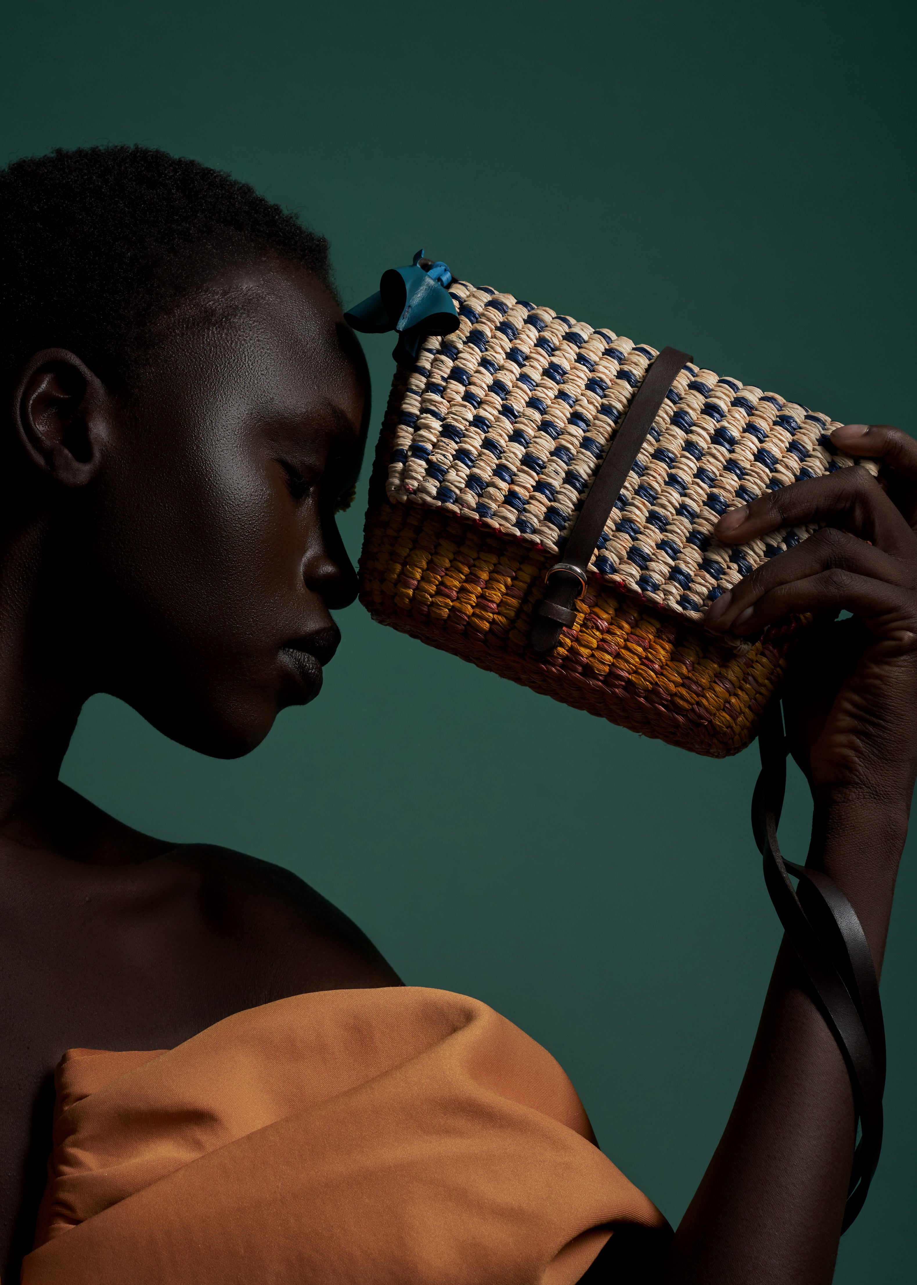 AAKS Bika Yellow handmade micro shoulder bag, held by model
