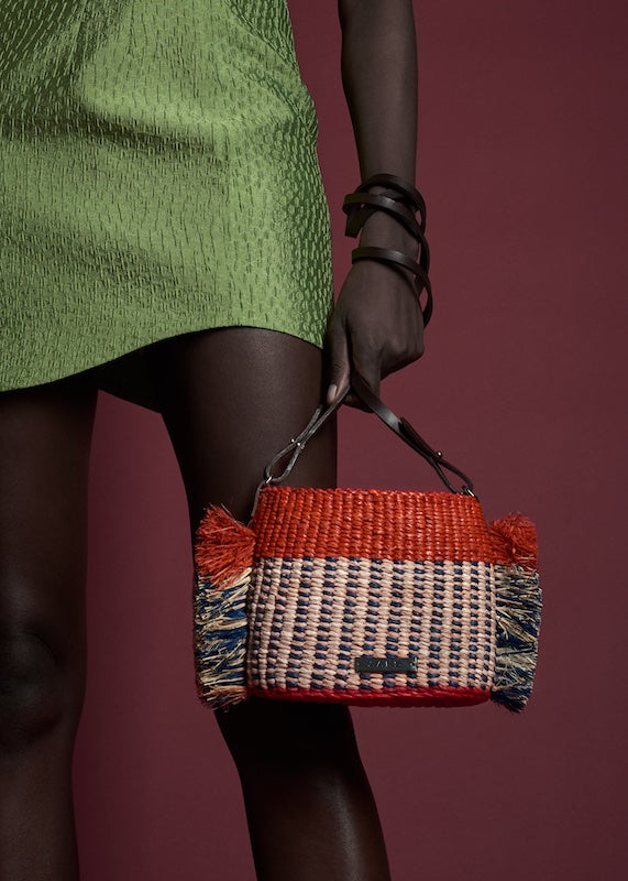 AAKS Hana Mini Tan Raffia bag, held by model