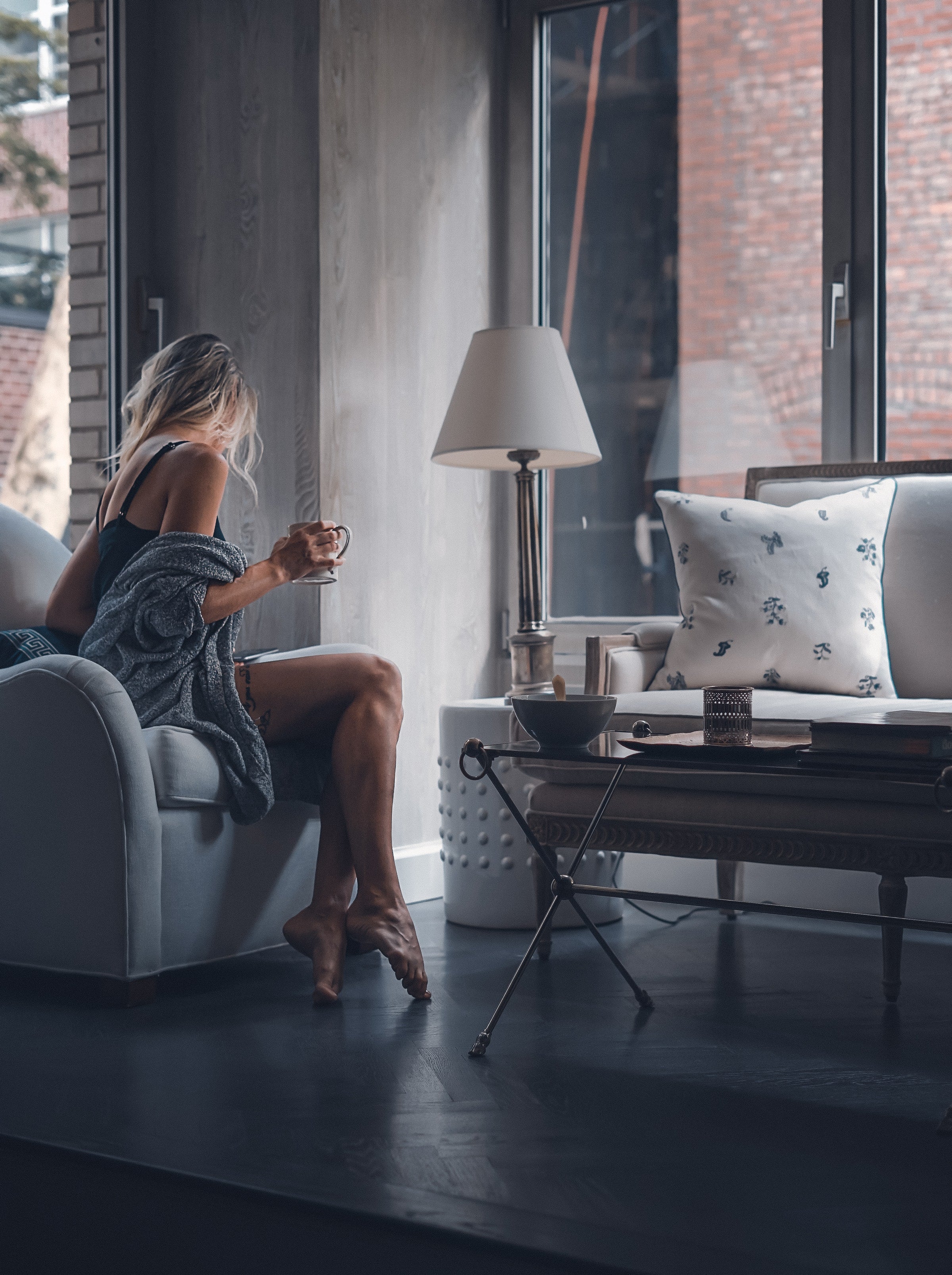 Lifestyle image of a woman relaxing with a cup of tea