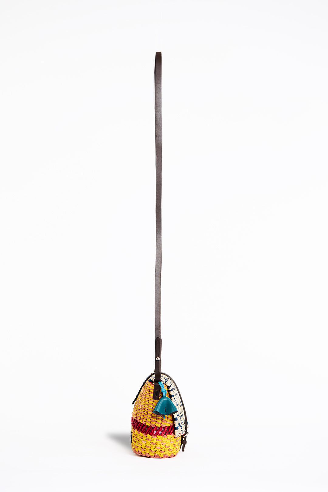 AAKS Bika Yellow handcrafted micro bag, long strap, profile  showing tassel